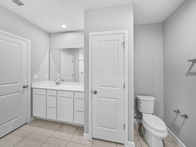 bathroom featuring tile patterned floors, toilet, and vanity