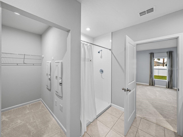 bathroom with tile patterned flooring and a shower with curtain