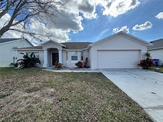 single story home featuring a garage and a front yard