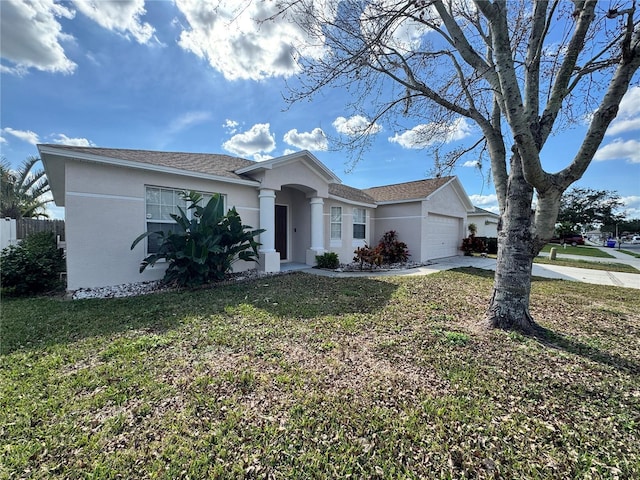 single story home featuring a garage and a front lawn