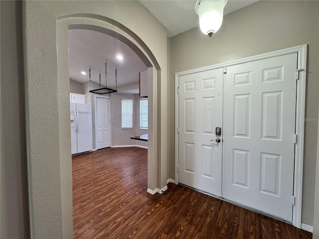 foyer featuring dark hardwood / wood-style floors and a textured ceiling