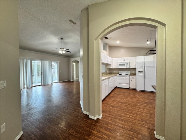 kitchen featuring lofted ceiling, white appliances, ceiling fan, white cabinetry, and dark hardwood / wood-style flooring