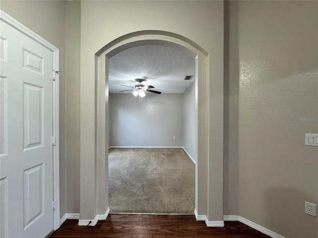 hall featuring dark hardwood / wood-style floors and a textured ceiling