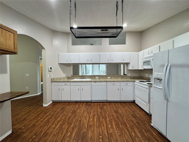 kitchen featuring dark hardwood / wood-style flooring, sink, white appliances, and white cabinets