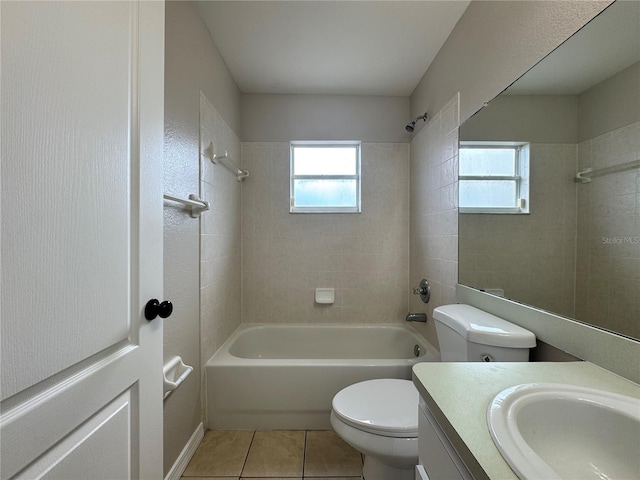 full bathroom with tiled shower / bath combo, vanity, tile patterned floors, and toilet