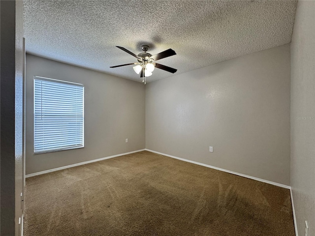 spare room featuring carpet floors, a textured ceiling, and ceiling fan