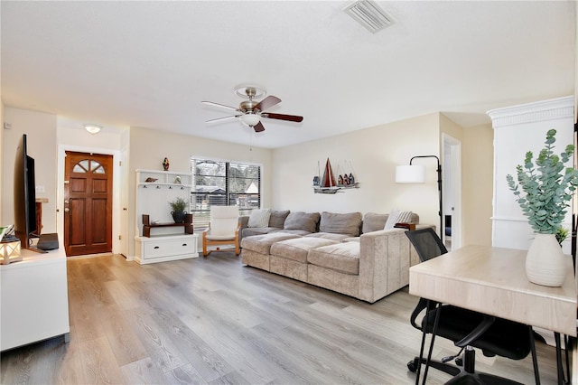 living area with a ceiling fan, light wood-type flooring, and visible vents