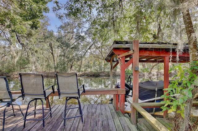 wooden terrace featuring a water view