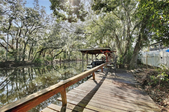 dock area featuring a water view and fence