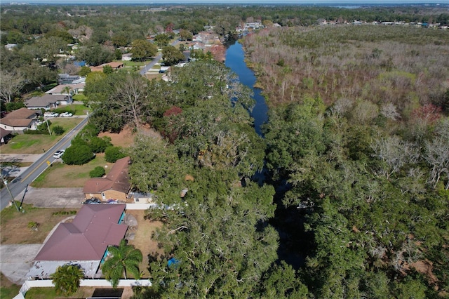 birds eye view of property featuring a water view and a view of trees