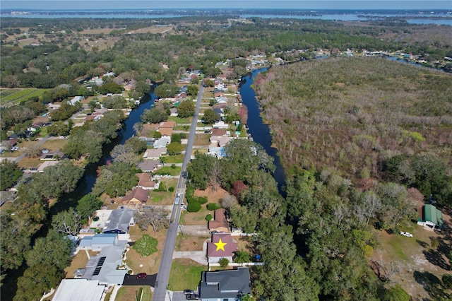 birds eye view of property featuring a residential view, a water view, and a forest view