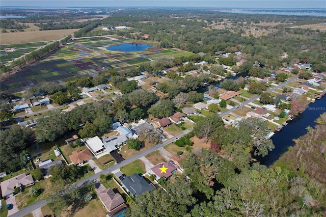 drone / aerial view with a water view and a residential view