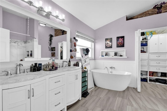 bathroom with vanity, separate shower and tub, and vaulted ceiling