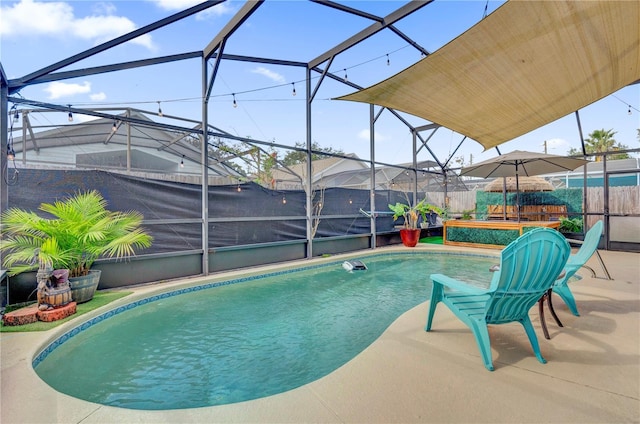 view of pool with a hot tub, a lanai, and a patio area