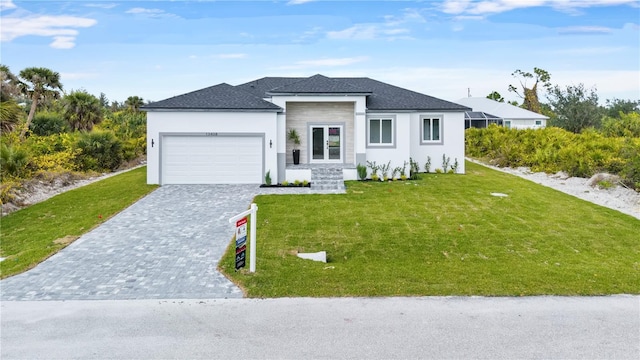 view of front of property with a garage and a front yard