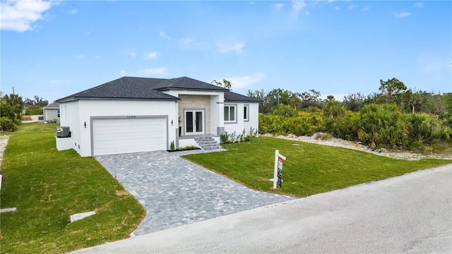 view of front of home with a garage and a front yard