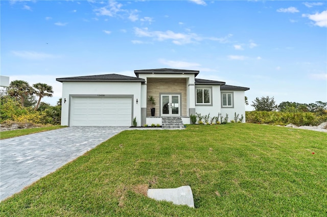 view of front of property with a garage and a front lawn