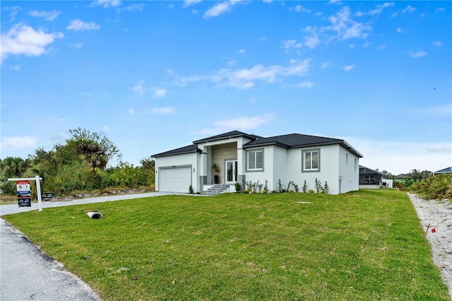 view of front facade with a garage and a front lawn