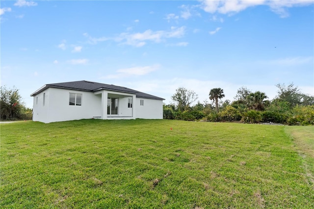 rear view of house with a lawn