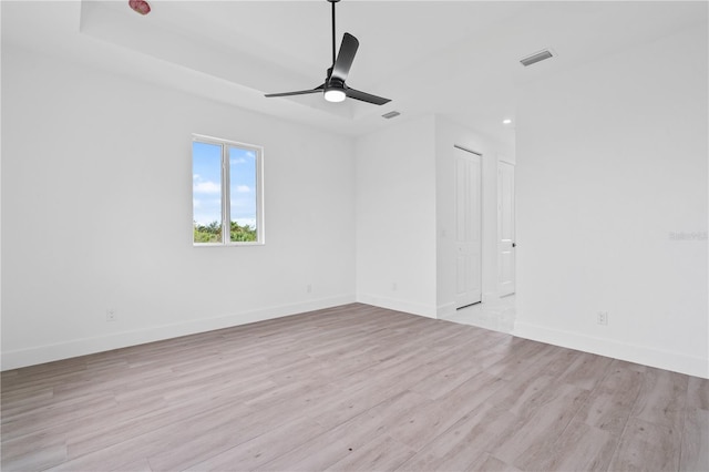 spare room featuring ceiling fan and light wood-type flooring