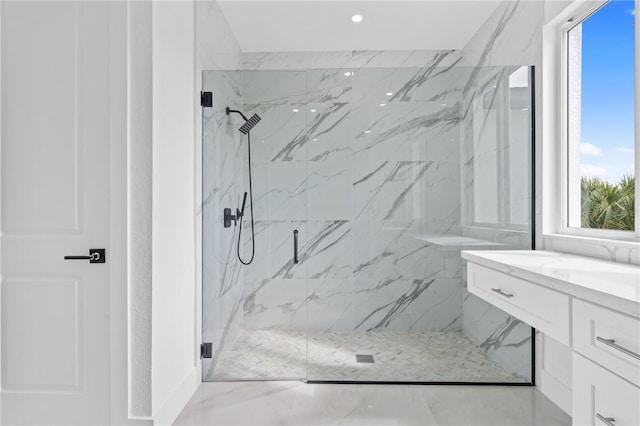 bathroom featuring vanity and a shower with door