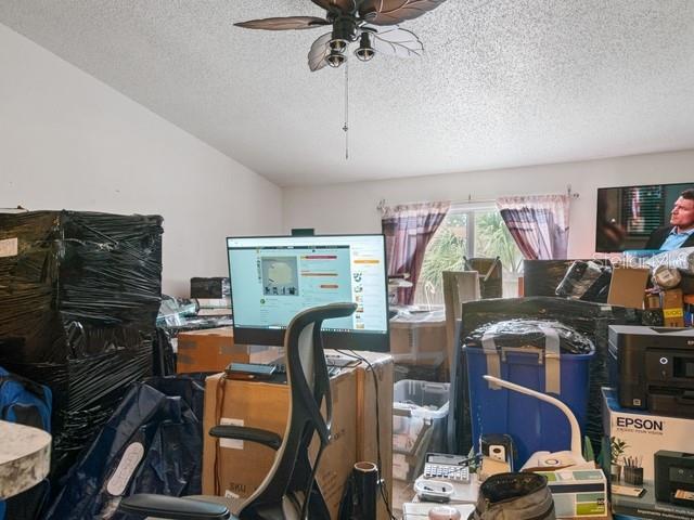 home office featuring a textured ceiling and ceiling fan