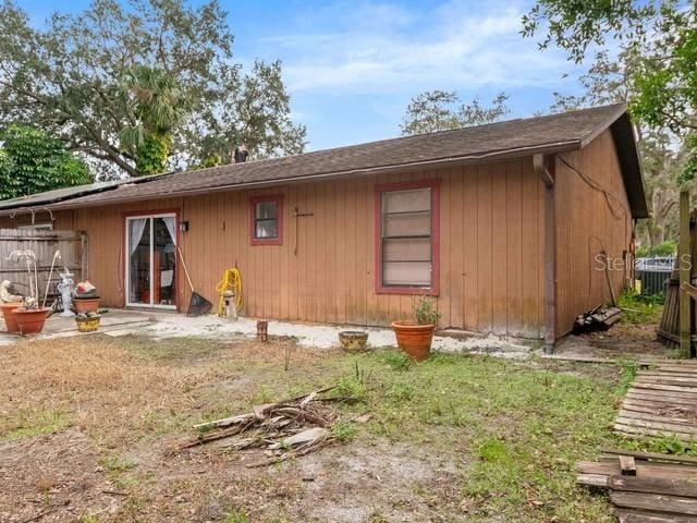 rear view of property with cooling unit