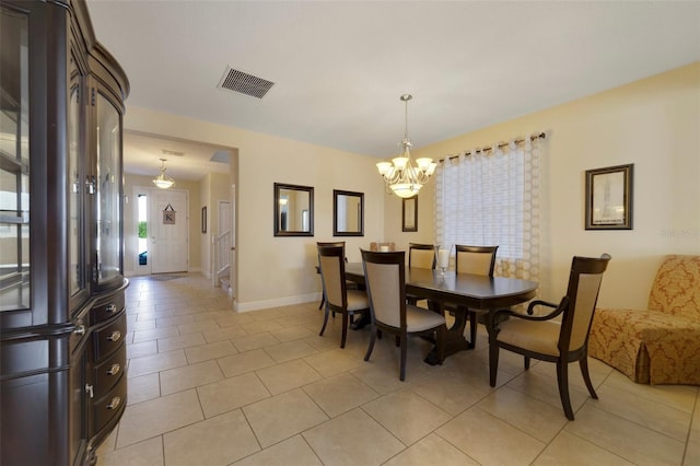 dining area with an inviting chandelier and light tile patterned floors