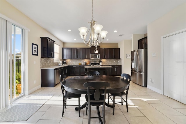 tiled dining area with an inviting chandelier