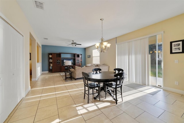 dining room with ceiling fan with notable chandelier and light tile patterned floors