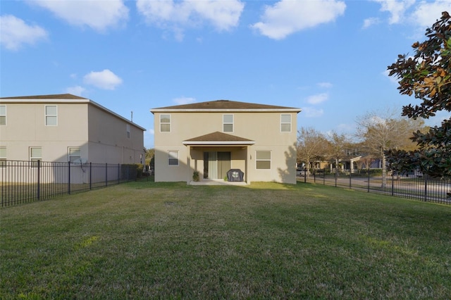 back of property featuring a lawn