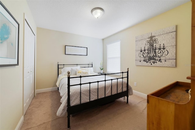 bedroom with light colored carpet and a closet