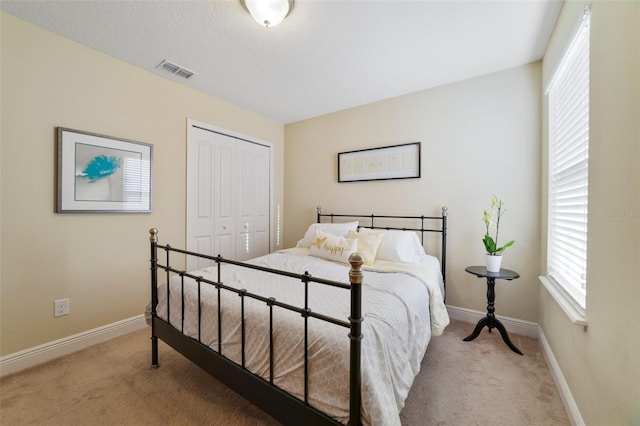 carpeted bedroom featuring a closet