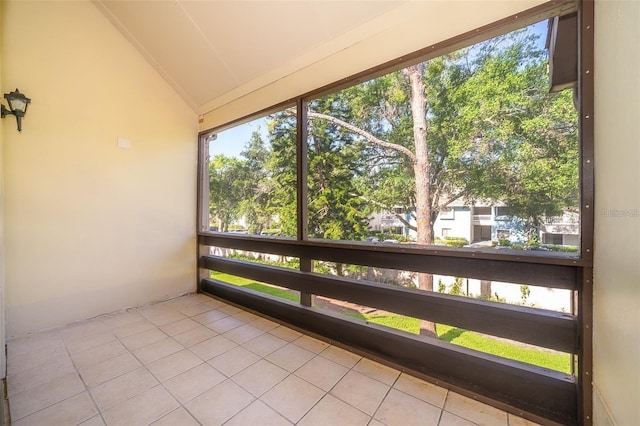 unfurnished sunroom featuring lofted ceiling