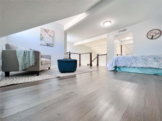 bedroom with hardwood / wood-style flooring and a textured ceiling