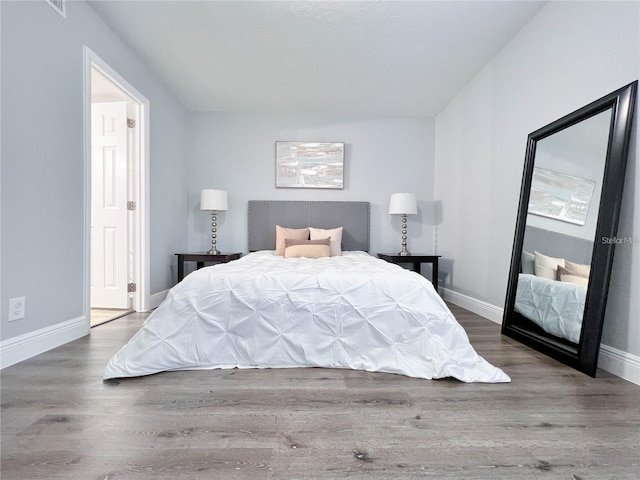 bedroom with hardwood / wood-style floors