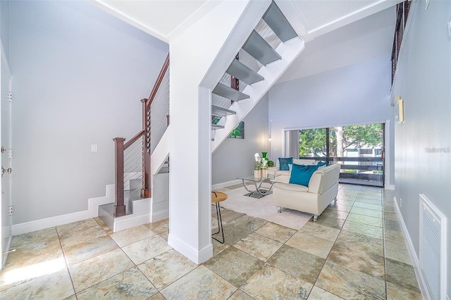 unfurnished living room featuring a high ceiling