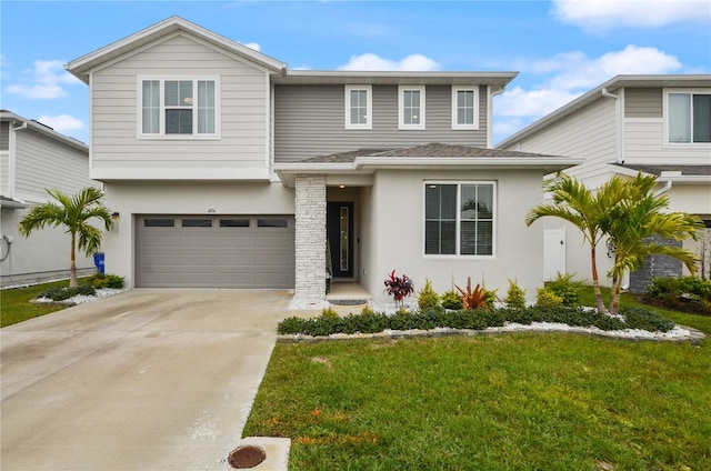 view of front of home with a garage and a front lawn