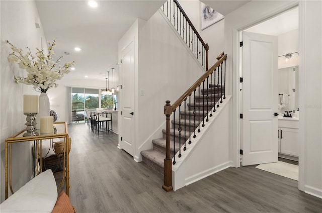 stairs with hardwood / wood-style flooring