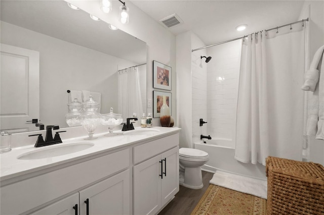 full bathroom featuring toilet, vanity, shower / bathtub combination with curtain, and hardwood / wood-style floors