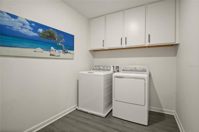 laundry room with dark hardwood / wood-style flooring, cabinets, and washer and dryer