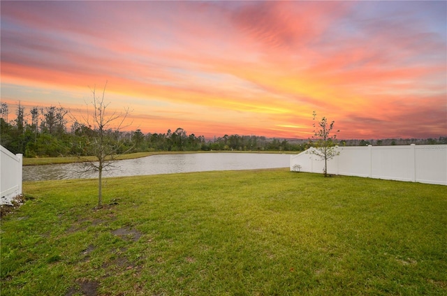 yard at dusk with a water view