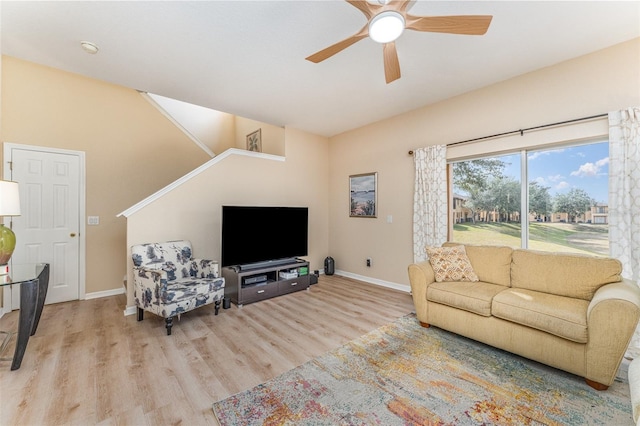 living room featuring ceiling fan and light hardwood / wood-style flooring