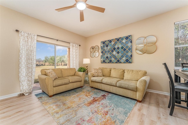 living room featuring ceiling fan and wood-type flooring