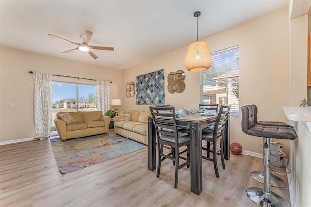 dining space with light hardwood / wood-style flooring, plenty of natural light, and ceiling fan