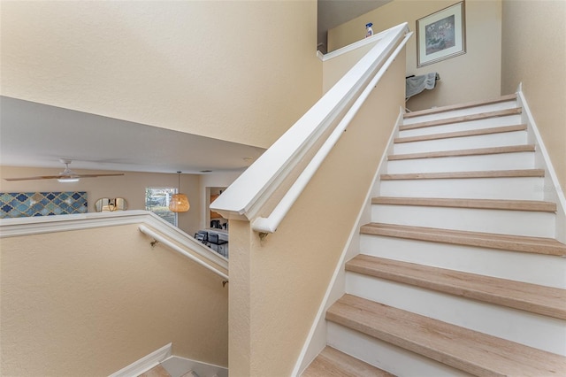 stairs with ceiling fan