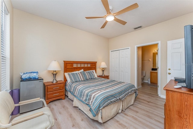 bedroom featuring ceiling fan, connected bathroom, a closet, and light wood-type flooring