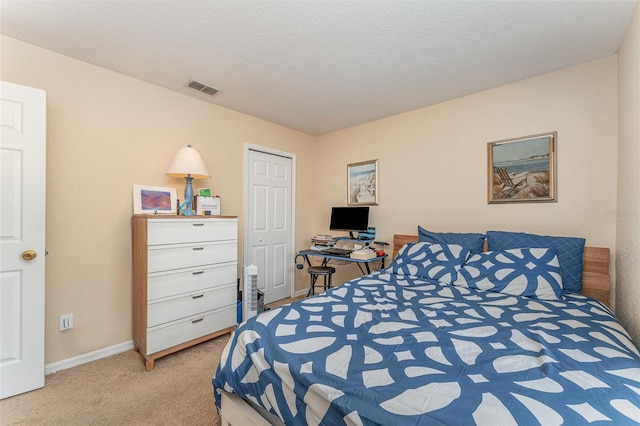 carpeted bedroom with a textured ceiling