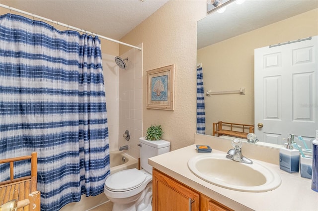 full bathroom with shower / tub combo with curtain, vanity, toilet, and a textured ceiling