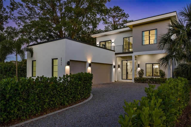 modern home with a balcony and a garage